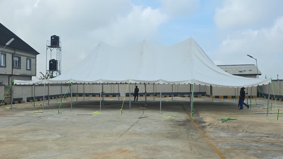 Large white sunblock canopy installed over the paved DRD Event Grounds
